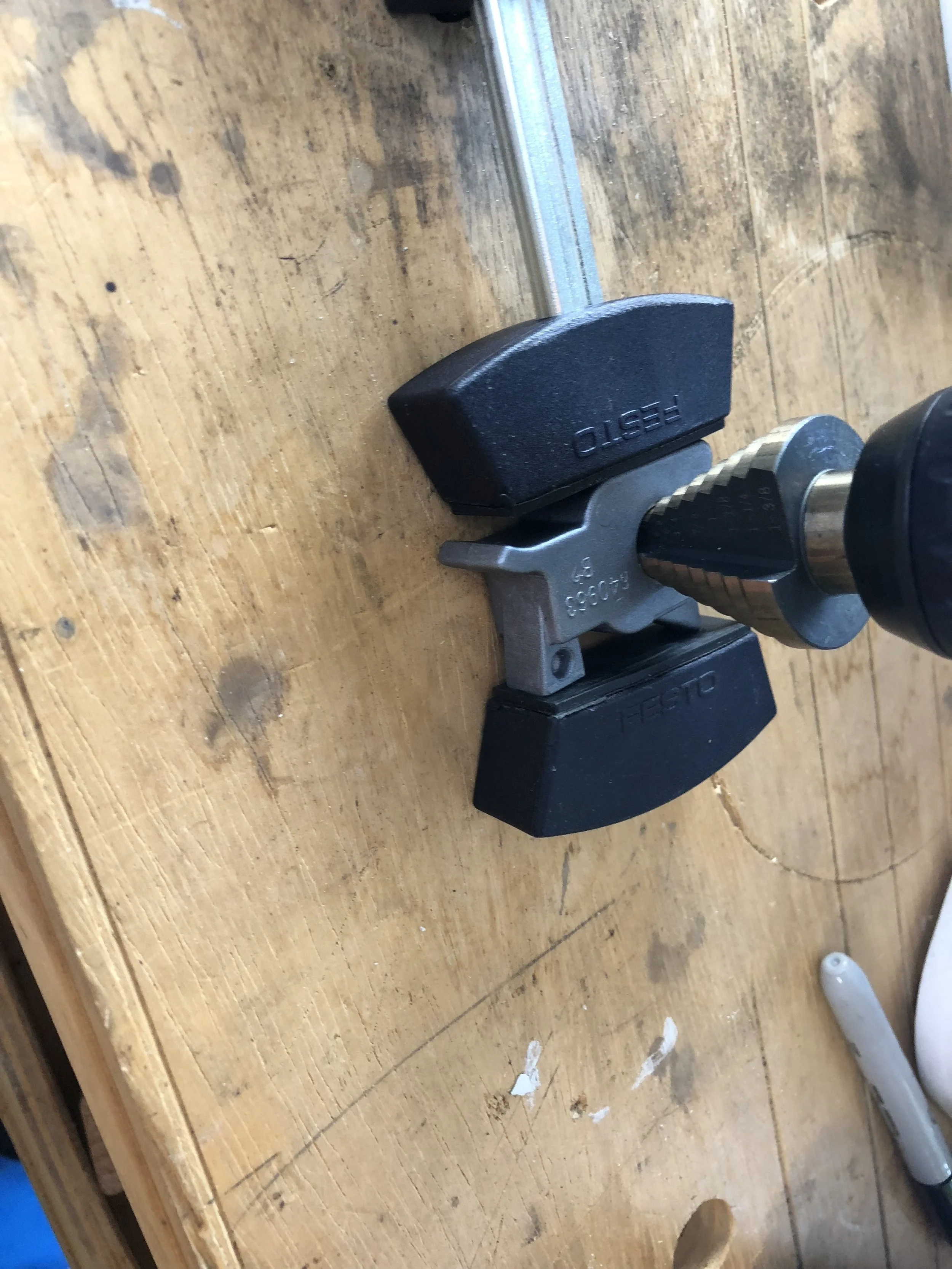  Drill slowly and check your progress often. The step drill will keep the bit centered (which is why I like to use it) but you need to be careful to not bore out the entire hole. We want a place for the sleeve bearing to stop when when we epoxy it in. 